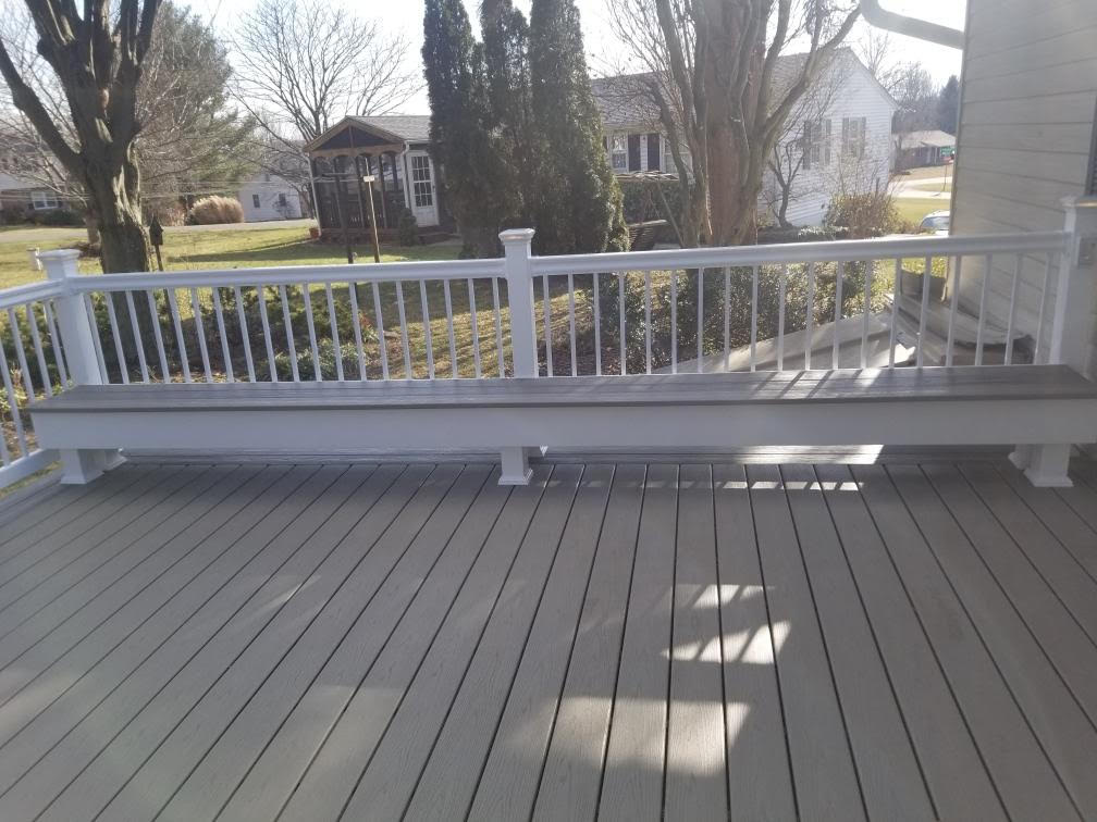 composite deck with a built in bench and white railings