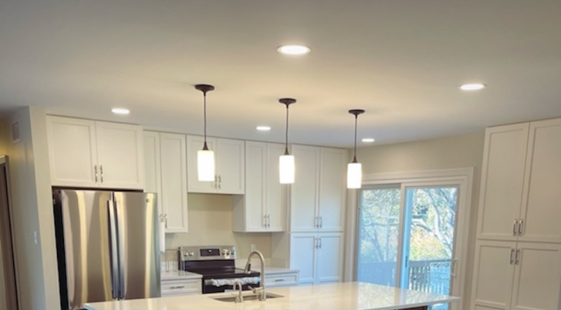 three modern ceiling light fixtures installed above a kitchen island